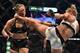 Holly Holm of the US (R) lands a kick to the neck to knock out compatriot Ronda Rousey and win the UFC title fight in Melbourne on November 15, 2015. RESTRICTED TO EDITORIAL USE NO ADVERTISING USE NO PROMOTIONAL USE NO MERCHANDISING USE. / AFP / PAUL