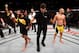 Assuncao (left) reacts after defeating Moraes.