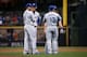 Max Muncy and the other Dodgers infielders confer during a pitching change.