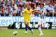 HUDDERSFIELD, ENGLAND - AUGUST 11: Eden Hazard of Chelsea is challenged by Jonathan Hogg of Huddersfield Town during the Premier League match between Huddersfield Town and Chelsea FC at John Smith's Stadium on August 11, 2018 in Huddersfield, United Kingd