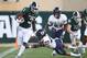 EAST LANSING, MI - AUGUST 31: LJ Scott #3 of the Michigan State Spartans tries to run through the tackle of Gaje Ferguson #23 of the Utah State Aggies at Spartan Stadium on August 31, 2018 in East Lansing, Michigan. (Photo by Gregory Shamus/Getty Images)