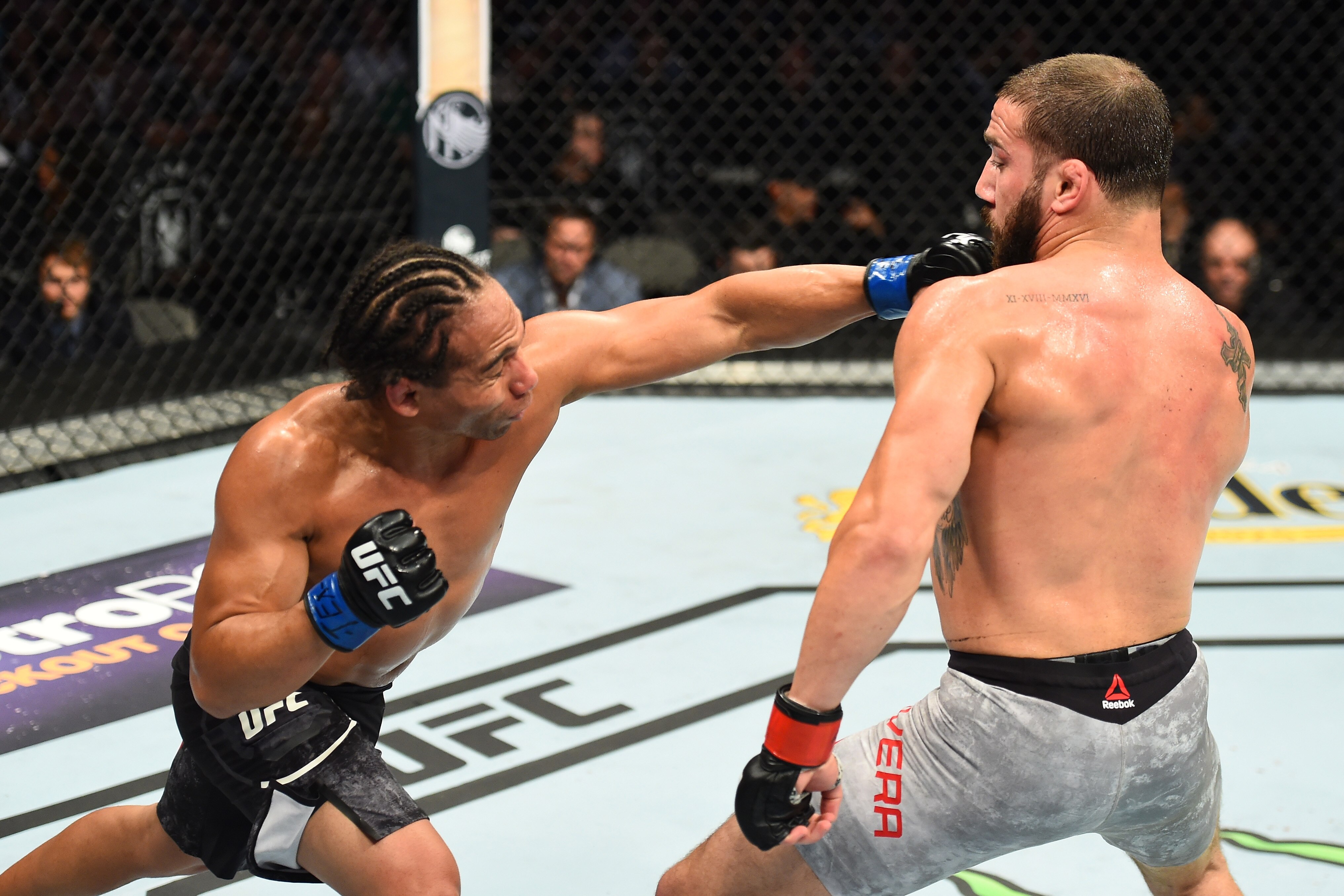 DALLAS, TX - SEPTEMBER 08:  (L-R) John Dodson punches Jimmie Rivera in their bantamweight fight during the UFC 228 event at American Airlines Center on September 8, 2018 in Dallas, Texas. (Photo by Josh Hedges/Zuffa LLC/Zuffa LLC via Getty Images)