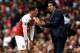 LONDON, ENGLAND - AUGUST 12: Unai Emery, Manager of Arsenal speaks with Mesut Ozil of Arsenal during the Premier League match between Arsenal FC and Manchester City at Emirates Stadium on August 12, 2018 in London, United Kingdom. (Photo by Shaun Botter