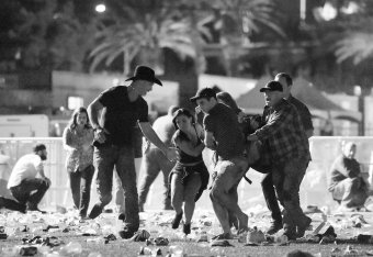 People carry a victim at the Route 91 Harvest country music festival after shots were fired.