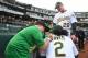 Anthony Slocumb (left) signs Davis' jersey hours before the Oakland slugger hit another of his 48 home runs this season.