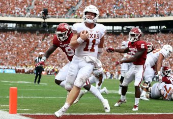 DALLAS, TX - OCTOBER 06:  Sam Ehlinger #11 of the Texas Longhorns smiles as he runs into the endzone for a touchdown against the Oklahoma Sooners in the second quarter of the 2018 AT&T Red River Showdown at Cotton Bowl on October 6, 2018 in Dallas, Texas.