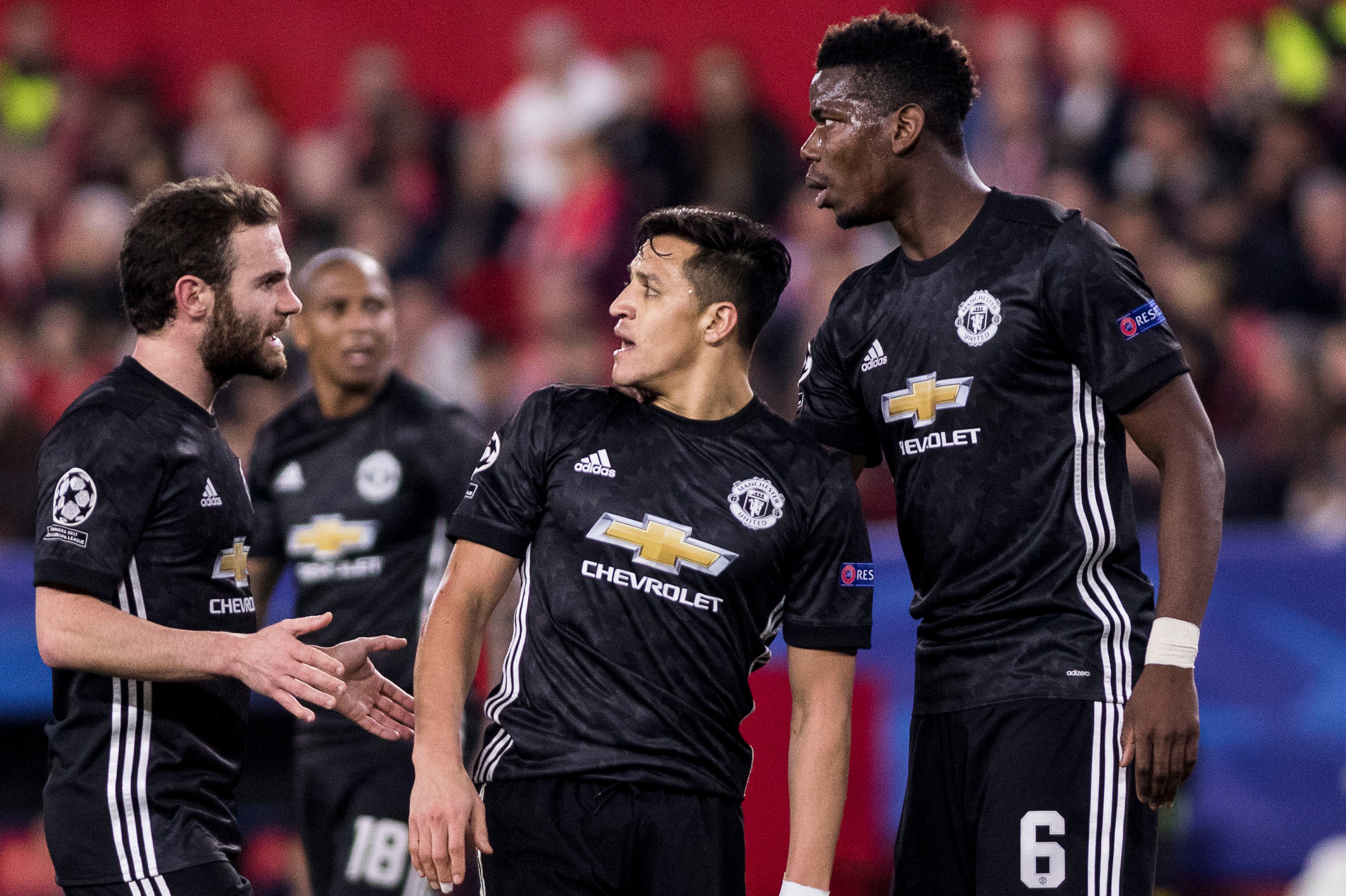 SEVILLE, SPAIN - FEBRUARY 21:  ALEXIS SANCHEZ (C ), JUAN MATA (L ) and PAUL POGBA (R ) argue after missing a chance at goal during the UEFA Champions League Round of 16 First Leg match between Sevilla FC and Manchester United at Estadio Ramon Sanchez Pizj