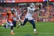 DENVER, CO - OCTOBER 14: Running back Todd Gurley #30 of the Los Angeles Rams scores a second quarter rushing touchdown as linebacker Todd Davis #51 of the Denver Broncos attempts to tackle him during a game at Broncos Stadium at Mile High on October 14,