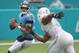 MIAMI, FL - SEPTEMBER 09: Quarterback Marcus Mariota #8 of the Tennessee Titans throws against Cameron Wake #91 of the Miami Dolphins at Hard Rock Stadium on September 9, 2018 in Miami, Florida. The Dolphins defeated the Titans 27-20 after two rain dela