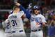 ATLANTA, GA - OCTOBER 07: Max Muncy #13 of the Los Angeles Dodgers celebrates with Joc Pederson #31 after hitting a solo home run in the fifth inning against the Atlanta Braves during Game Three of the National League Division Series at SunTrust Park on