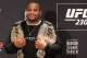 Cormier showing off both his UFC belts.