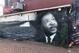 A mural of Martin Luther King, Jr. adorns the side of a market in a neighborhood of Southeast Washington, D.C.