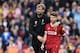 Liverpool's German manager Jurgen Klopp (L) walks with Liverpool's Spanish defender Alberto Moreno during the English Premier League football match between Liverpool and Stoke City at Anfield in Liverpool, north west England on April 28, 2018. (Photo by P