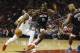 HOUSTON, TX - OCTOBER 24: Donovan Mitchell #45 of the Utah Jazz drives to the basket defended by Clint Capela #15 of the Houston Rockets and PJ Tucker #17 in the first half at Toyota Center on October 24, 2018 in Houston, Texas. NOTE TO USER: User expre