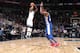 Jimmy Butler shooting over Joel Embiid.