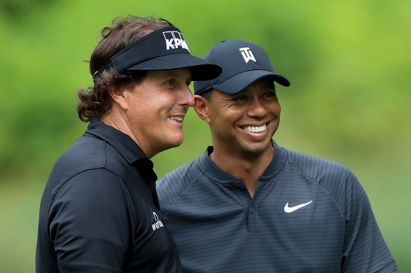 AKRON, OH - AUGUST 01:  Phil Mickelson (L) and Tiger Woods smile during a practice round prior to the World Golf Championships-Bridgestone Invitational at Firestone Country Club South Course on August 1, 2018 in Akron, Ohio.  (Photo by Sam Greenwood/Getty
