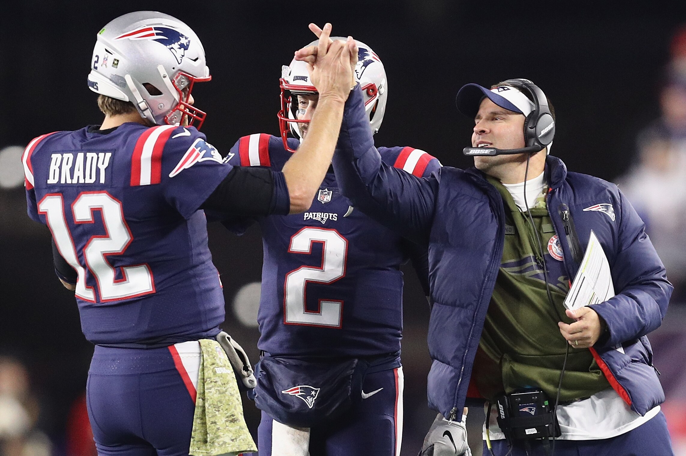 FOXBOROUGH, MA - NOVEMBER 04:  Tom Brady #12 of the New England Patriots high fives Brian Hoyer #2 and offensive coordinator Josh McDaniels during the second half against the Green Bay Packers at Gillette Stadium on November 4, 2018 in Foxborough, Massach