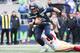 SEATTLE, WA - DECEMBER 02: Russell Wilson #3 of the Seattle Seahawks avoids a tackle by Malcolm Smith #51 of the San Francisco 49ers in the first half at CenturyLink Field on December 2, 2018 in Seattle, Washington. (Photo by Abbie Parr/Getty Images)