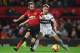 Manchester United's Spanish midfielder Juan Mata (L) vies with Fulham's English defender Joe Bryan during the English Premier League football match between Manchester United and Fulham at Old Trafford in Manchester, north west England, on December 8, 2018
