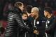 Paris Saint-Germain's French forward Kylian Mbappe (C) is congratulated by Paris Saint-Germain's German coach Thomas Tuchel (L) at the end of the European Champions League football match Crvena Zvezda Belgrade vs Paris Saint-Germain (PSG) on December 11,