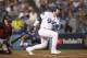 LOS ANGELES, CA - OCTOBER 26: Yasmani Grandal #9 of the Los Angeles Dodgers singles during the fifth inning against the Boston Red Sox in Game Three of the 2018 World Series at Dodger Stadium on October 26, 2018 in Los Angeles, California. (Photo by Ezr