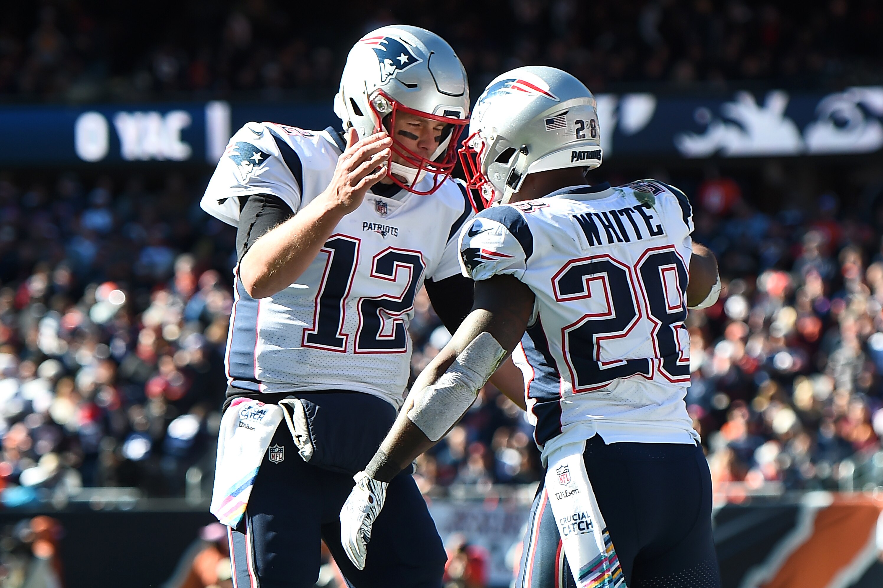 CHICAGO, IL - OCTOBER 21:  Quarterback Tom Brady #12 of the New England Patriots and James White #28 celebrate after White scored against the Chicago Bears in the second quarter at Soldier Field on October 21, 2018 in Chicago, Illinois.  (Photo by Stacy R