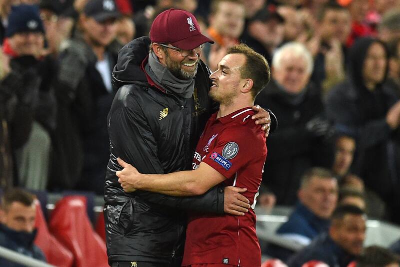 Liverpool's German manager Jurgen Klopp chats with Liverpool's Swiss midfielder Xherdan Shaqiri (R) as he's substituted during the UEFA Champions League group C football match between Liverpool and Red Star Belgrade at Anfield in Liverpool, north west Eng