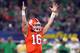 ARLINGTON, TEXAS - DECEMBER 29: Trevor Lawrence #16 of the Clemson Tigers reacts after throwing a 19 yard touchdown pass in the second quarter against the Notre Dame Fighting Irish during the College Football Playoff Semifinal Goodyear Cotton Bowl Classic