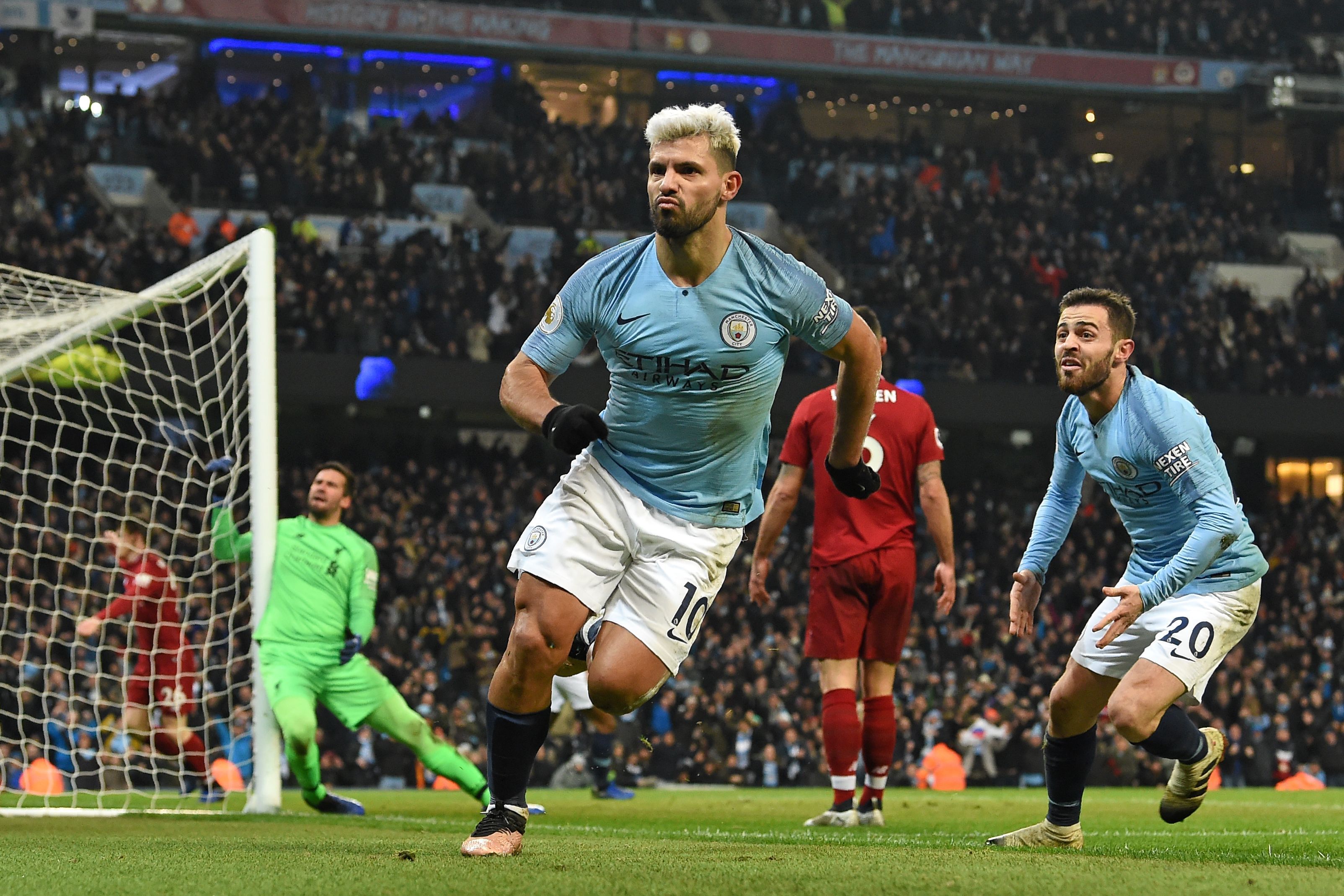 Manchester City's Argentinian striker Sergio Aguero (C) celebrates after scoring the opening goal of the English Premier League football match between Manchester City and Liverpool at the Etihad Stadium in Manchester, north west England, on January 3, 201