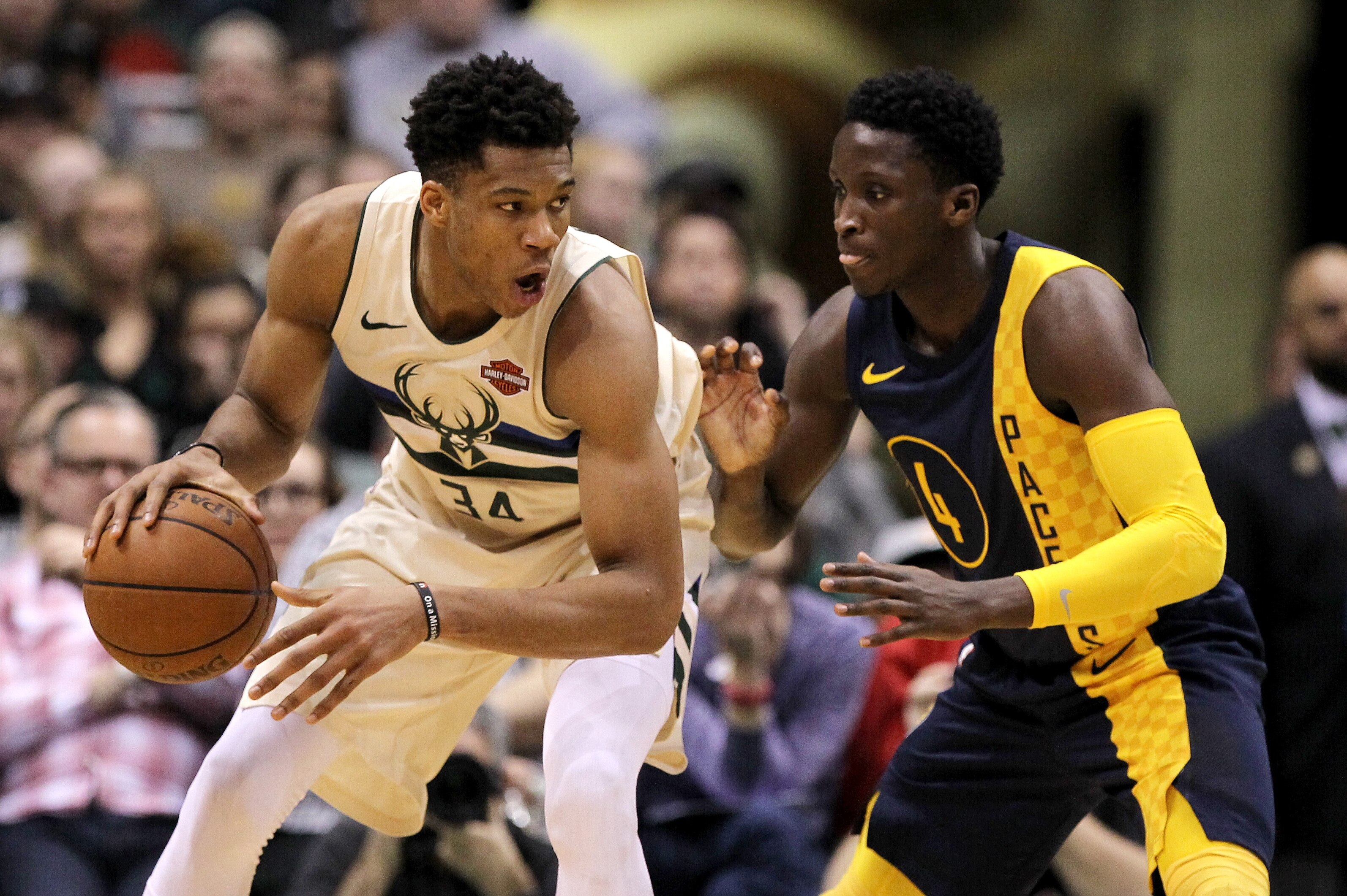 MILWAUKEE, WI - MARCH 02: Giannis Antetokounmpo #34 of the Milwaukee Bucks dribbles the ball while being guarded by Victor Oladipo #4 of the Indiana Pacers in the fourth quarter at the Bradley Center on March 2, 2018 in Milwaukee, Wisconsin. NOTE TO USER