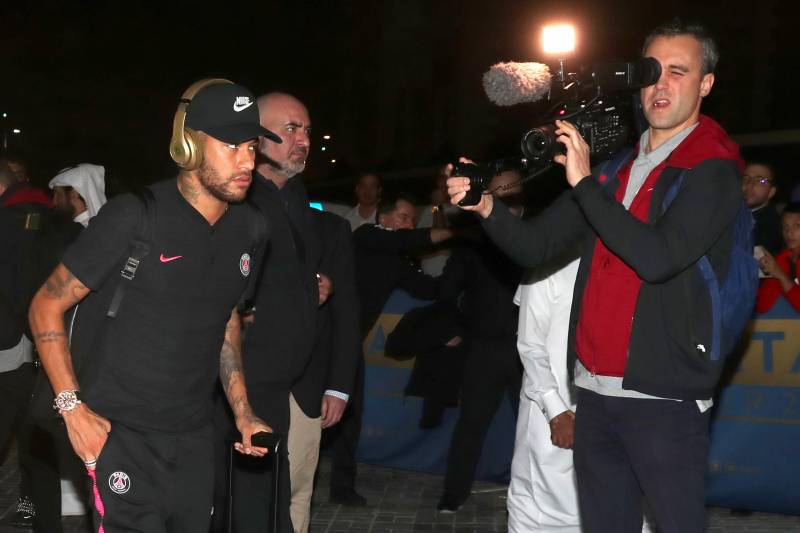 Paris Saint-Germain's Brazilian forward Neymar is greeted by fans as he leaves Doha's International Airport where the French football team arrived to take part in the Aspire Academy winter training camp on January 13, 2019. (Photo by KARIM JAAFAR / AFP)  