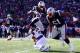 FOXBOROUGH, MASSACHUSETTS - JANUARY 13: Sony Michel #26 of the New England Patriots leaps over Jahleel Addae #37 of the Los Angeles Chargers during the first quarter in the AFC Divisional Playoff Game at Gillette Stadium on January 13, 2019 in Foxborough,