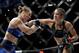 Nunes (right) punches Rousey