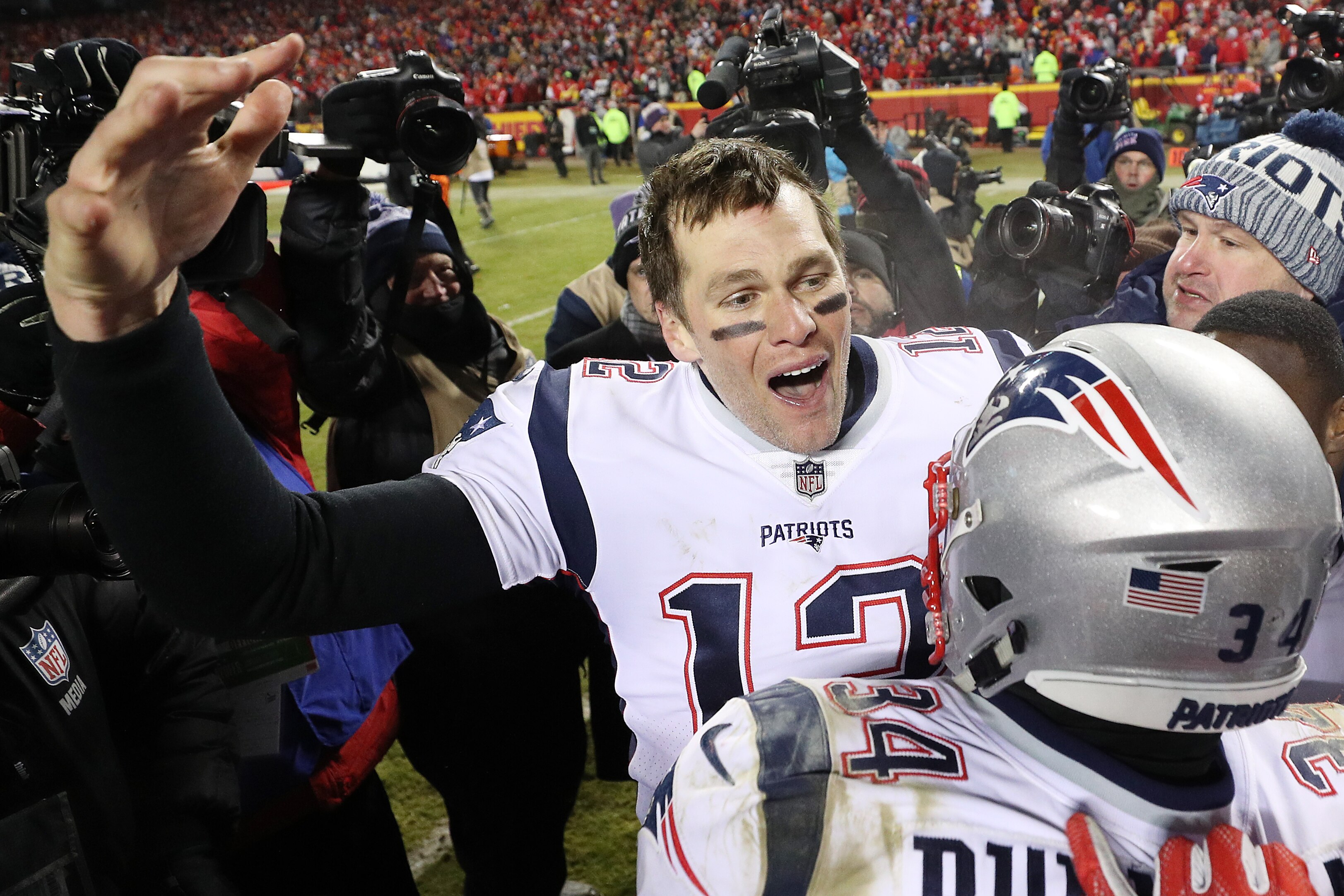 KANSAS CITY, MISSOURI - JANUARY 20: Tom Brady #12 of the New England Patriots celebrates with Rex Burkhead #34 after defeating the Kansas City Chiefs in overtime during the AFC Championship Game at Arrowhead Stadium on January 20, 2019 in Kansas City, Mis