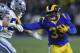 LOS ANGELES, CA - JANUARY 12: Los Angeles Rams running back C.J. Anderson #35 stiff arms Dallas Cowboys outside linebacker Leighton Vander Esch #55 at Los Angeles Memorial Coliseum on January 12, 2019 in Los Angeles, California. (Photo by John McCoy/Getty