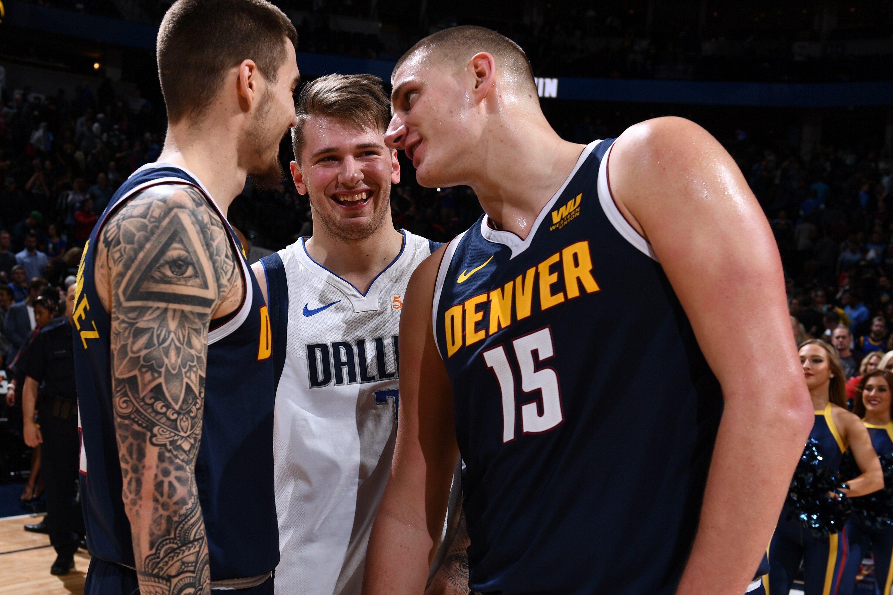 DENVER, CO - DECEMBER 18: Luka Doncic #77 of the Dallas Mavericks talks with Juan Hernangomez #41 and Nikola Jokic #15 of the Denver Nuggets on December 18, 2018 at the Pepsi Center in Denver, Colorado. NOTE TO USER: User expressly acknowledges and agree