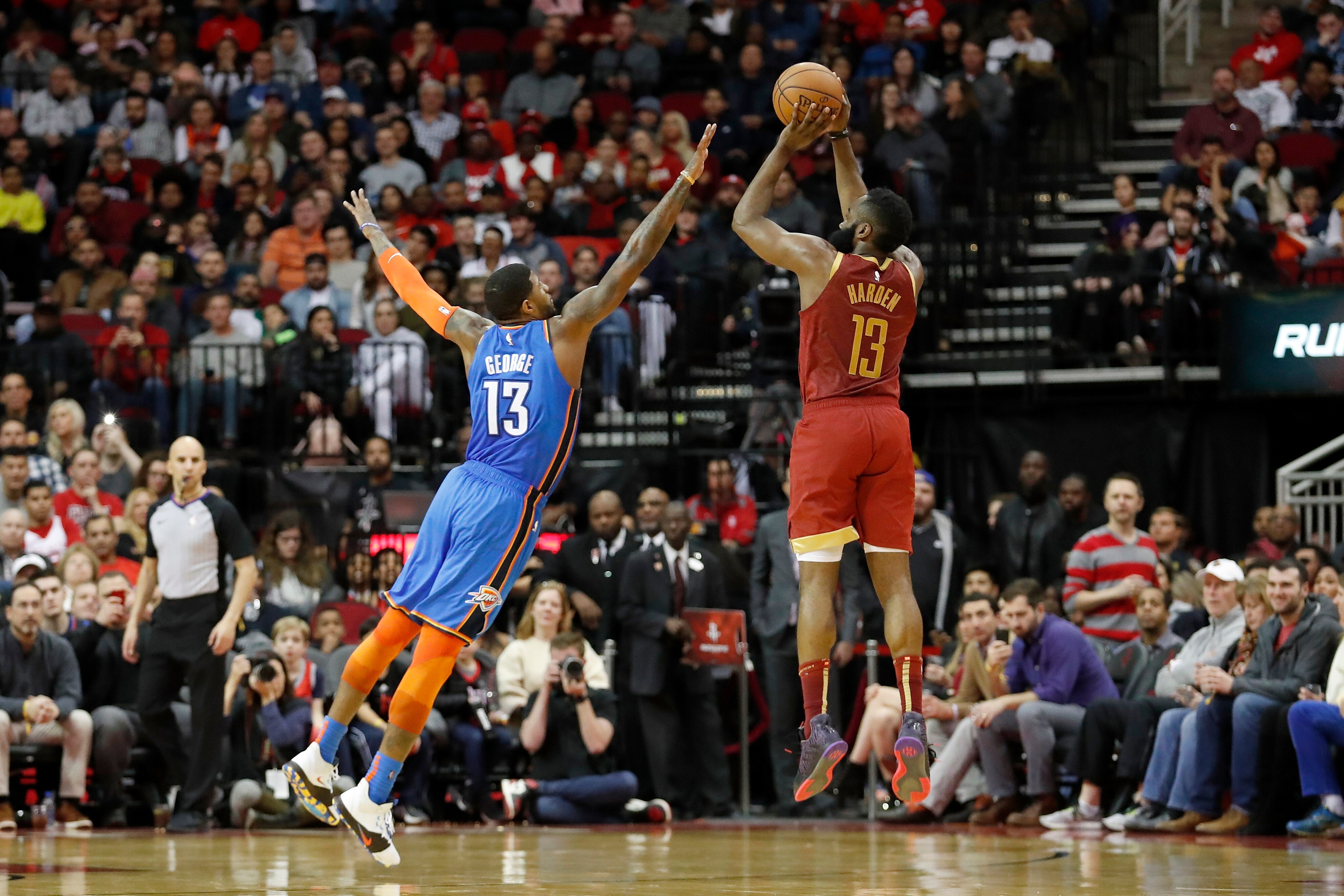 HOUSTON, TX - FEBRUARY 09: James Harden #13 of the Houston Rockets takes a three point shot defended by Paul George #13 of the Oklahoma City Thunder in the second half at Toyota Center on February 9, 2019 in Houston, Texas. NOTE TO USER: User expressly 