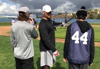 Maxwell, pictured in the white cap, spent some time this February helping disabled young people learn how to play baseball.