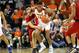 CHARLOTTESVILLE, VA - MARCH 09: De'Andre Hunter #12 of the Virginia Cavaliers grabs a loose ball away from Jordan Nwora #33 of the Louisville Cardinals in the second half during a game at John Paul Jones Arena on March 9, 2019 in Charlottesville, Virginia