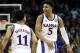 KANSAS CITY, MISSOURI - MARCH 15: Quentin Grimes #5 of the Kansas Jayhawks celebrates with Devon Dotson #11 after making a three-pointer during the semifinal game of the Big 12 Basketball Tournament against the West Virginia Mountaineers at Sprint Center