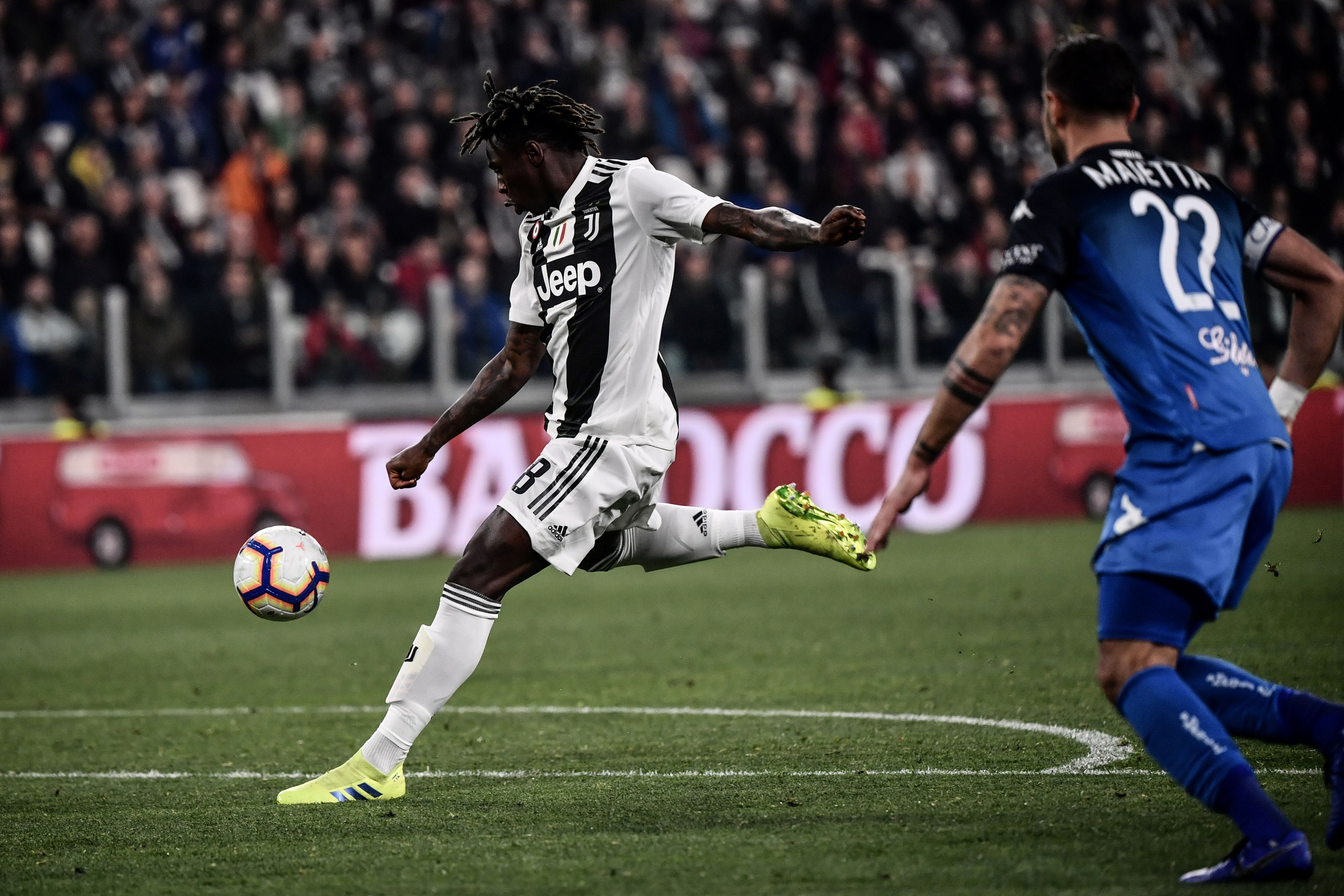 Juventus' Italian forward Moise Kean shoots to open the scoring during the Italian Serie A football match Juventus vs Empoli on March 30, 2019 at the Juventus stadium in Turin. (Photo by Marco BERTORELLO / AFP) (Photo credit should read MARCO BERTO