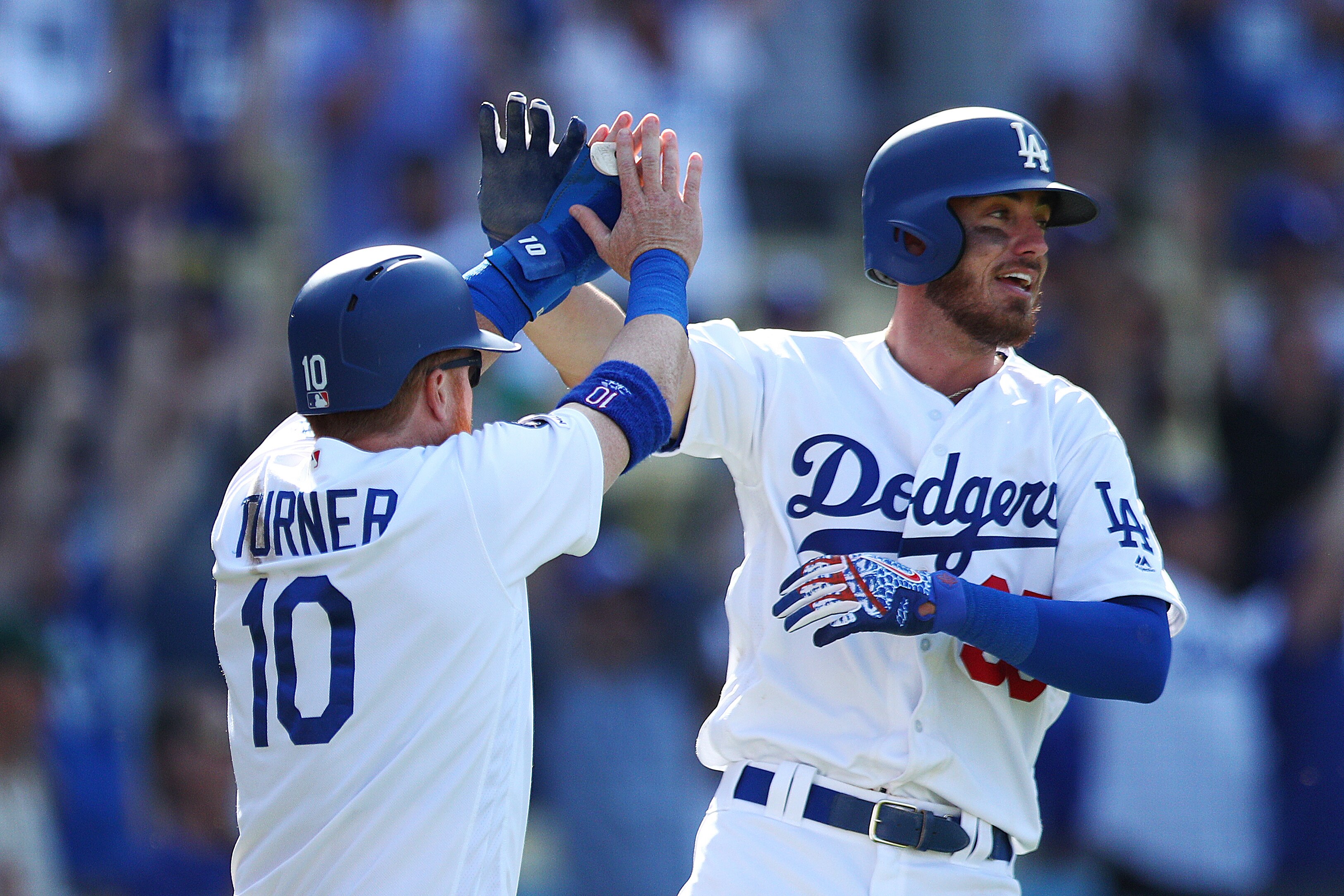LOS ANGELES, CALIFORNIA - MARCH 31: Justin Turner #10 and Cody Bellinger #35 of the Los Angeles Dodgers celebrate scoring against the Arizona Diamondbacks during the eighth inning at Dodger Stadium on March 31, 2019 in Los Angeles, California. (Photo by Y