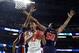 MINNEAPOLIS, MINNESOTA - APRIL 06: De'Andre Hunter #12 of the Virginia Cavaliers drives to the basket against Horace Spencer #0 and Austin Wiley #50 of the Auburn Tigers in the second half during the 2019 NCAA Final Four semifinal at U.S. Bank Stadium on