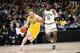 CHICAGO, ILLINOIS - MARCH 17: Ignas Brazdeikis #13 of the Michigan Wolverines dribbles the ball while being guarded by Aaron Henry #11 of the Michigan State Spartans in the second half during the championship game of the Big Ten Basketball Tournament at