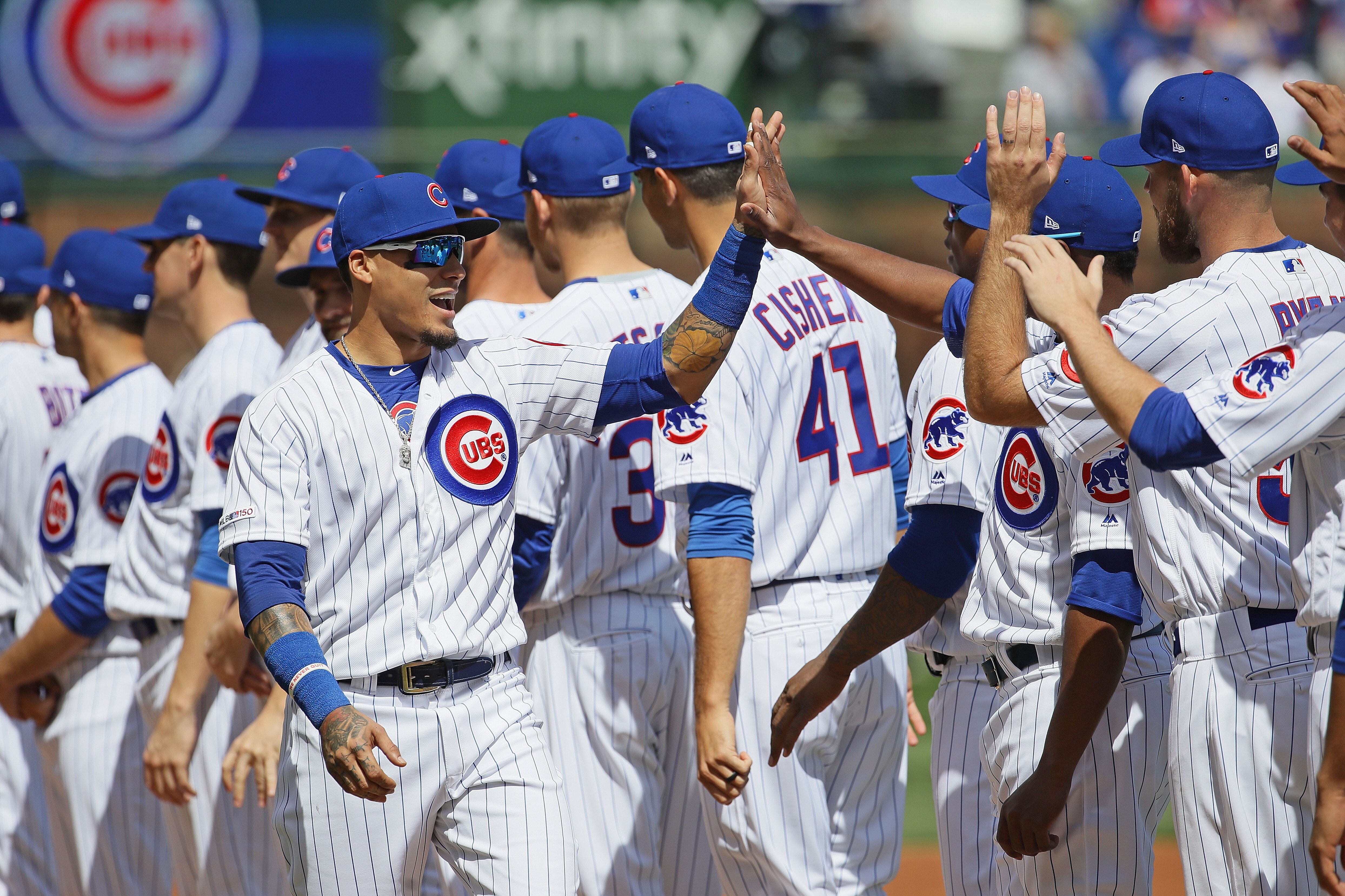 CHICAGO, ILLINOIS - APRIL 08: Javier Baez #9 of the Chicago Cubs greets teammates during player introductions before the home opening game against the Pittsburgh Pirates at Wrigley Field on April 08, 2019 in Chicago, Illinois. The Cubs defeated the Pirate