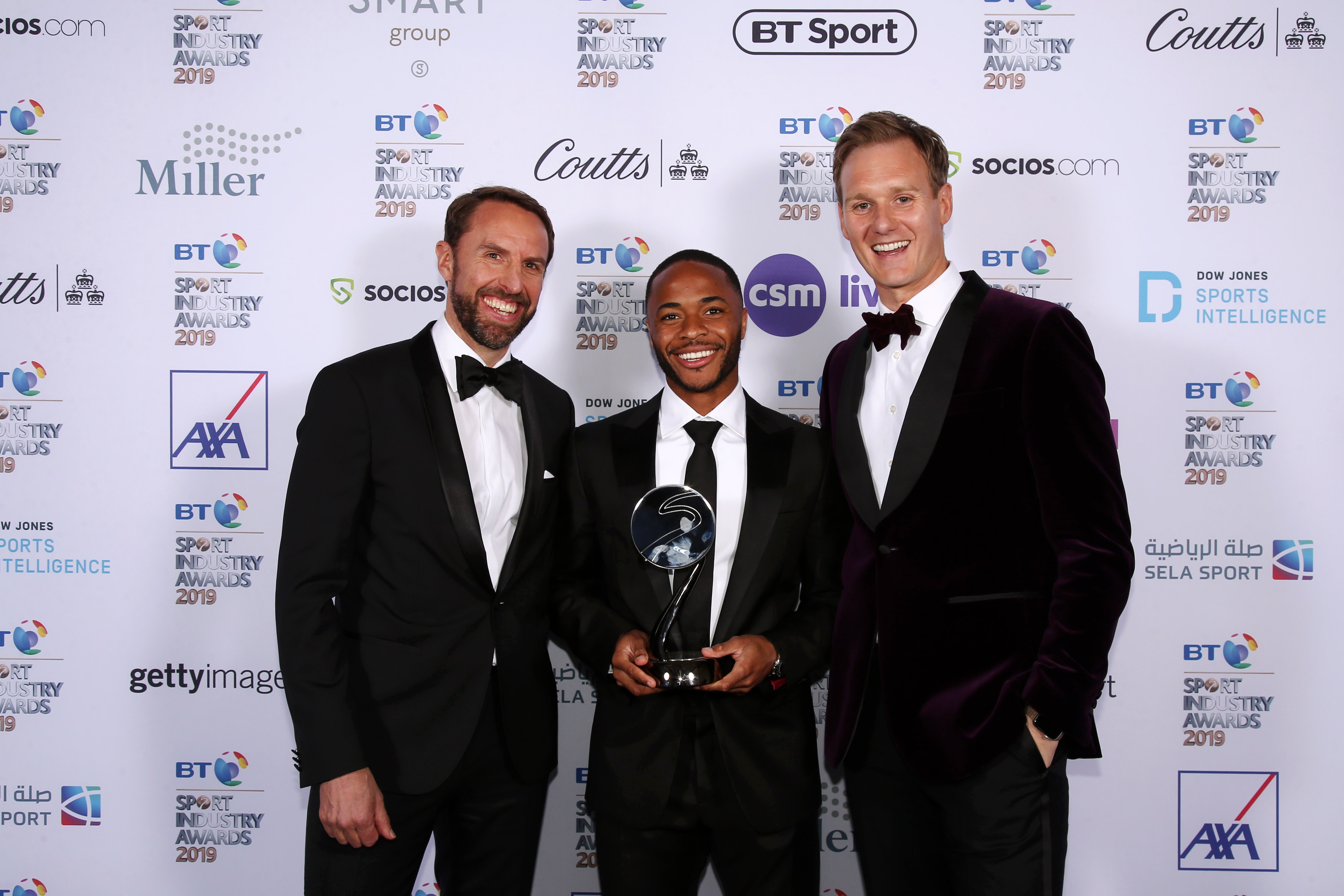 LONDON, ENGLAND - APRIL 25: Gareth Southgate, Manager of England (L) and Dan Walker (R) pose for a photo with The Integrity and Impact Award founded by Dow Jones Intelligence winner, Raheem Sterling (C) at the BT Sport Industry Awards 2019 at Battersea Ev