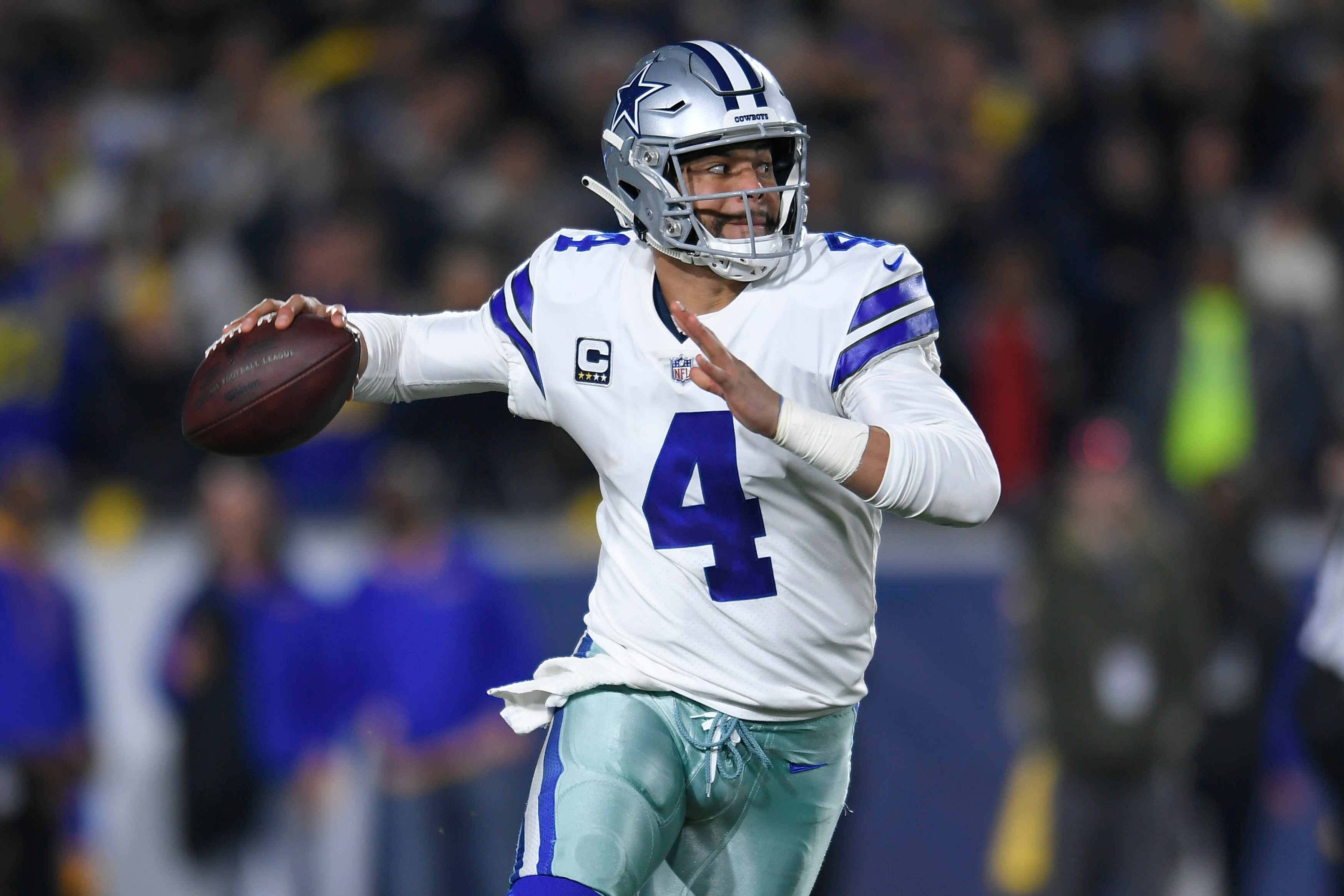 LOS ANGELES, CA - JANUARY 12: Dallas Cowboys quarterback Dak Prescott #4 rolls out against the Los Angeles Rams at Los Angeles Memorial Coliseum on January 12, 2019 in Los Angeles, California. (Photo by John McCoy/Getty Images)