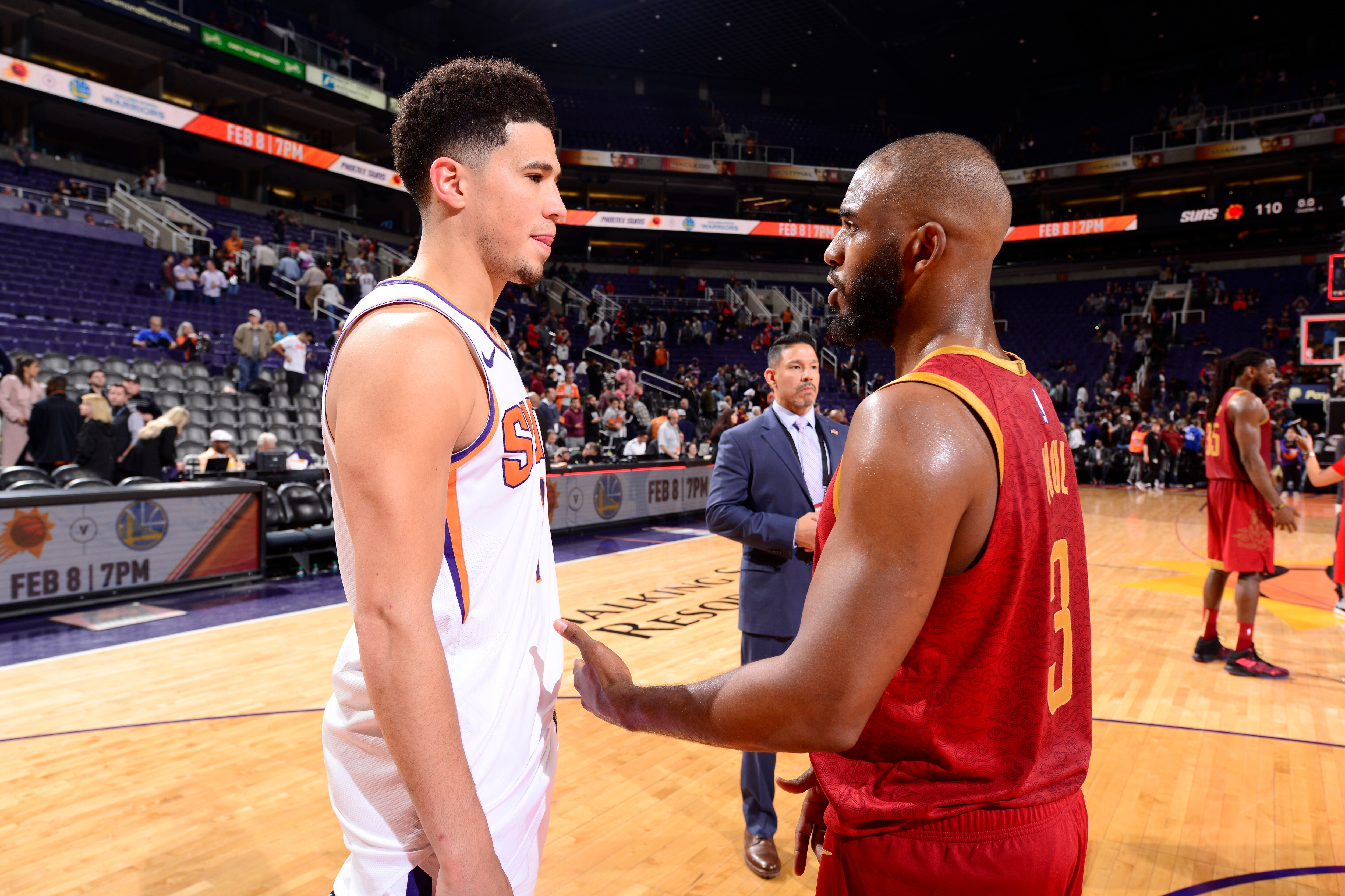 PHOENIX, AZ - FEBRUARY 4: Devin Booker #1 of the Phoenix Suns and Chris Paul #3 of the Houston Rockets talk after the game on February 4. 2019 at Talking Stick Resort Arena in Phoenix, Arizona. NOTE TO USER: User expressly acknowledges and agrees that, by