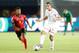 Tunisia's midfielder Ellyes Skhiri (R) passes the ball as he is marked by Angola's midfielder Fredy Kulembe during the 2019 Africa Cup of Nations (CAN) football match between Tunisia and Angola at the Suez Stadium in Suez on June 24, 2019. (Photo by FADEL