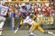 ANAHEIM, CA - SEPTEMBER 6: Earl Campbell #34 of the Houston Oilers gets tackled by Nolan Cromwell #21 of the Los Angeles Rams during an NFL Football game September 6, 1981 at Anaheim Stadium in Anaheim, California. Campbell played for the Oilers from 19